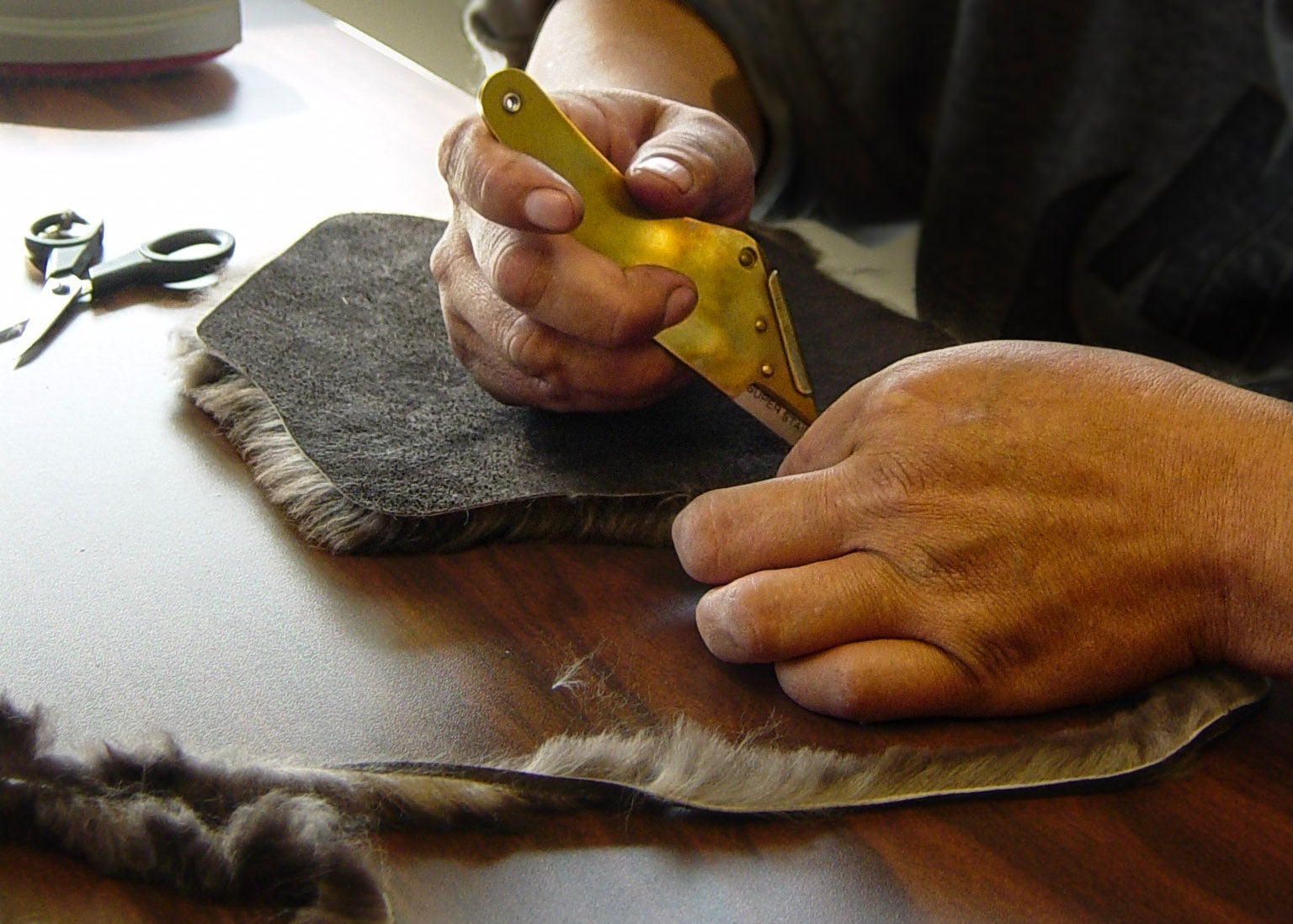 Cutting beaver pelt to be knit into sheared beaver fur garments